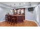 Finished basement with a wooden wet bar, complete with seating and a mounted television at 1207 Promontory Path, Marietta, GA 30062