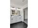 Modern bathroom with double vanity, black hardware, and sleek black tile floor at 2831 Ivanhoe Se Ln, Smyrna, GA 30082