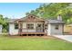 Charming renovated home featuring a welcoming porch, new siding, fresh paint, and a beautifully manicured front lawn at 2831 Ivanhoe Se Ln, Smyrna, GA 30082