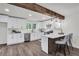 Beautiful updated kitchen featuring white cabinets, stainless steel appliances, an eat-in bar, and stylish pendant lighting at 2831 Ivanhoe Se Ln, Smyrna, GA 30082