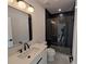 Contemporary bathroom featuring modern vanity, stylish mirror, and black tiled glass enclosed shower at 380 Hillcrest View Dr, Suwanee, GA 30024