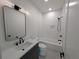 Modern bathroom featuring a sleek vanity, a stylish mirror and a bathtub with white subway tile at 380 Hillcrest View Dr, Suwanee, GA 30024