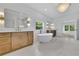 Luxurious bathroom with a soaking tub, double vanity, marble floors and modern chandelier at 380 Hillcrest View Dr, Suwanee, GA 30024