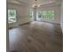 Spacious bedroom with hardwood floors and large windows allowing lots of natural light at 380 Hillcrest View Dr, Suwanee, GA 30024
