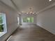 Light-filled bedroom offers hardwood floors and large windows with scenic views at 380 Hillcrest View Dr, Suwanee, GA 30024