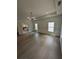 Bright bedroom boasts hardwood floors and multiple windows overlooking a lush landscape at 380 Hillcrest View Dr, Suwanee, GA 30024