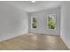 Clean bedroom featuring hardwood floors and large windows for lots of natural light at 380 Hillcrest View Dr, Suwanee, GA 30024