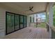 Spacious covered deck with ceiling fan and folding glass doors, offering seamless transition to outdoor entertainment at 380 Hillcrest View Dr, Suwanee, GA 30024