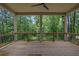 Covered deck with wood flooring and wrought iron railing offering a peaceful outdoor retreat surrounded by trees at 380 Hillcrest View Dr, Suwanee, GA 30024