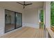 Covered deck features an outdoor ceiling fan and sliding glass door for indoor-outdoor living and entertaining at 380 Hillcrest View Dr, Suwanee, GA 30024