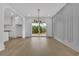 Open dining area showcasing hardwood floors, modern lighting, and sliding glass doors to back deck at 380 Hillcrest View Dr, Suwanee, GA 30024
