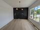 Dining area with statement wall, hardwood floors and large window at 380 Hillcrest View Dr, Suwanee, GA 30024