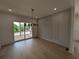 Dining area features an accent wall, hardwood floors and sliding glass doors to outside at 380 Hillcrest View Dr, Suwanee, GA 30024