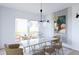 Bright dining room with modern chandelier, marble table, seating for six, and patio access at 380 Hillcrest View Dr, Suwanee, GA 30024