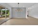 Spacious open area with sliding glass doors, hardwood floors, and modern chandelier at 380 Hillcrest View Dr, Suwanee, GA 30024