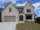 Elegant two-story home features a painted brick exterior and a well-manicured lawn at 380 Hillcrest View Dr, Suwanee, GA 30024