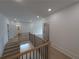 Well-lit hallway featuring hardwood floors, a staircase, and access to multiple rooms at 380 Hillcrest View Dr, Suwanee, GA 30024