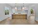 Bright kitchen featuring a large island with ample seating and modern pendant lighting at 380 Hillcrest View Dr, Suwanee, GA 30024