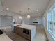 Open-concept kitchen featuring a large island, stainless steel appliances, and hardwood floors at 380 Hillcrest View Dr, Suwanee, GA 30024