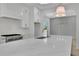 Close up of kitchen with a large island, stainless steel appliances, and a stylish backsplash at 380 Hillcrest View Dr, Suwanee, GA 30024