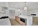 Open concept kitchen featuring a large island, stainless steel appliances, and stylish pendant lighting at 380 Hillcrest View Dr, Suwanee, GA 30024