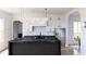 Modern kitchen features sleek island with cooktop, stainless steel appliances and white cabinets at 380 Hillcrest View Dr, Suwanee, GA 30024
