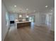 Open-concept kitchen and living area featuring an island with modern lighting and stainless steel appliances at 380 Hillcrest View Dr, Suwanee, GA 30024