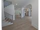 Open-concept living space boasts hardwood floors, modern lighting, and an arched entryway to the kitchen at 380 Hillcrest View Dr, Suwanee, GA 30024