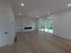 Living room with fireplace, built in shelving and glass doors to outside at 380 Hillcrest View Dr, Suwanee, GA 30024