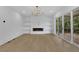 Spacious living room with fireplace and built-in shelving and sliding door access to deck at 380 Hillcrest View Dr, Suwanee, GA 30024