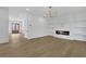 Open-concept living room with modern fireplace and built-in shelving and hardwood floors at 380 Hillcrest View Dr, Suwanee, GA 30024
