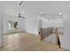 Bright loft area features hardwood floors, neutral paint, large window and modern black railing for stairs at 380 Hillcrest View Dr, Suwanee, GA 30024