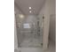 Modern shower with a glass door and marble tile surround with a bench at 380 Hillcrest View Dr, Suwanee, GA 30024