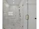 Beautiful walk-in shower with marble surround, bench seat, and gold hardware at 380 Hillcrest View Dr, Suwanee, GA 30024