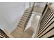 Modern staircase with neutral wood and black iron railing at 380 Hillcrest View Dr, Suwanee, GA 30024