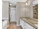 Bathroom featuring a double sink vanity with granite countertops and tiled floors at 1635 Round Rd, Grayson, GA 30017