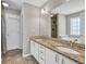 Bathroom featuring a double sink vanity with granite countertops and tiled floors at 1635 Round Rd, Grayson, GA 30017