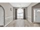 Charming dining room with hardwood floors, wainscotting and arched window at 1635 Round Rd, Grayson, GA 30017