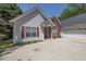 Charming single-Gathering home with an attached two-car garage and manicured flowerbeds at 1635 Round Rd, Grayson, GA 30017