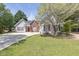 Attractive single-story home with red shutters, flowering tree and well-maintained lawn at 1635 Round Rd, Grayson, GA 30017