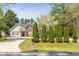 Charming single-story home with manicured lawn, inviting entrance, and long driveway at 1635 Round Rd, Grayson, GA 30017