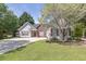 Attractive single-story home with red shutters, flowering tree and well-maintained lawn at 1635 Round Rd, Grayson, GA 30017