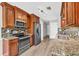 Kitchen featuring stainless steel appliances, granite countertops, and wood cabinets at 1635 Round Rd, Grayson, GA 30017