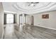Spacious living room with hardwood floors and decorative trey ceiling at 1635 Round Rd, Grayson, GA 30017