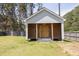 Storage shed with wooden doors, siding and plenty of storage space at 1635 Round Rd, Grayson, GA 30017
