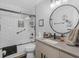 Modern bathroom featuring subway tile in shower, updated vanity with large round mirror at 219 Riverbrook Ct, Mcdonough, GA 30252