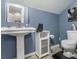 Charming bathroom with a vintage-style sink and blue painted walls at 219 Riverbrook Ct, Mcdonough, GA 30252
