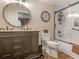 Well-appointed bathroom with a granite-topped vanity, decorative mirror, and tub-shower combo at 219 Riverbrook Ct, Mcdonough, GA 30252