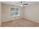 Inviting carpeted bedroom with natural light and a ceiling fan for added comfort at 219 Riverbrook Ct, Mcdonough, GA 30252