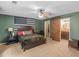 Stylish bedroom with a flag tapestry, barn door entry, and a ceiling fan at 219 Riverbrook Ct, Mcdonough, GA 30252